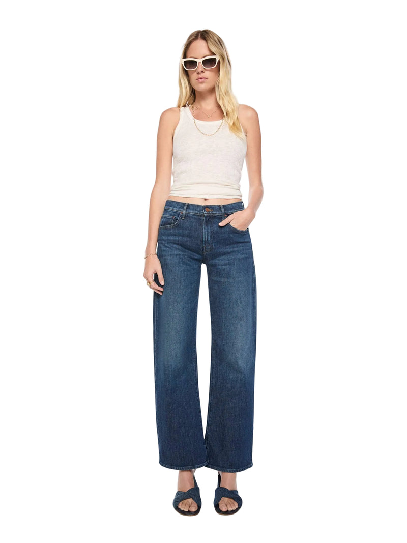 Woman wearing blue jeans and a white top on a white background