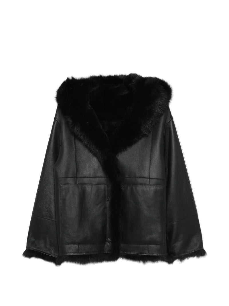A black lamb leather cape jacket with a plush black fur collar and hem, displayed against a plain white background.