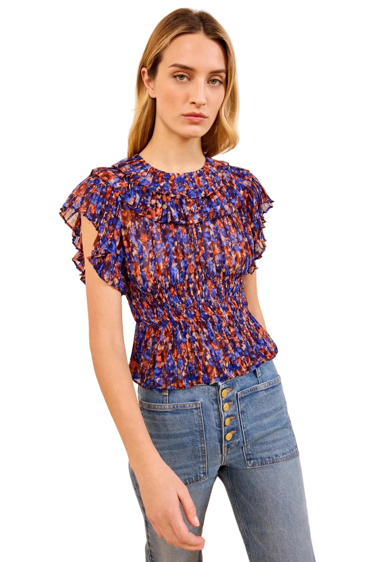 Woman wearing a patterned top and jeans by Ulla Johnson