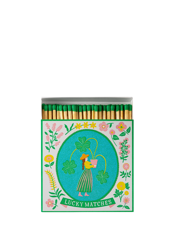 Matches with a decorative cover featuring a woman, flowers, and text on a white background