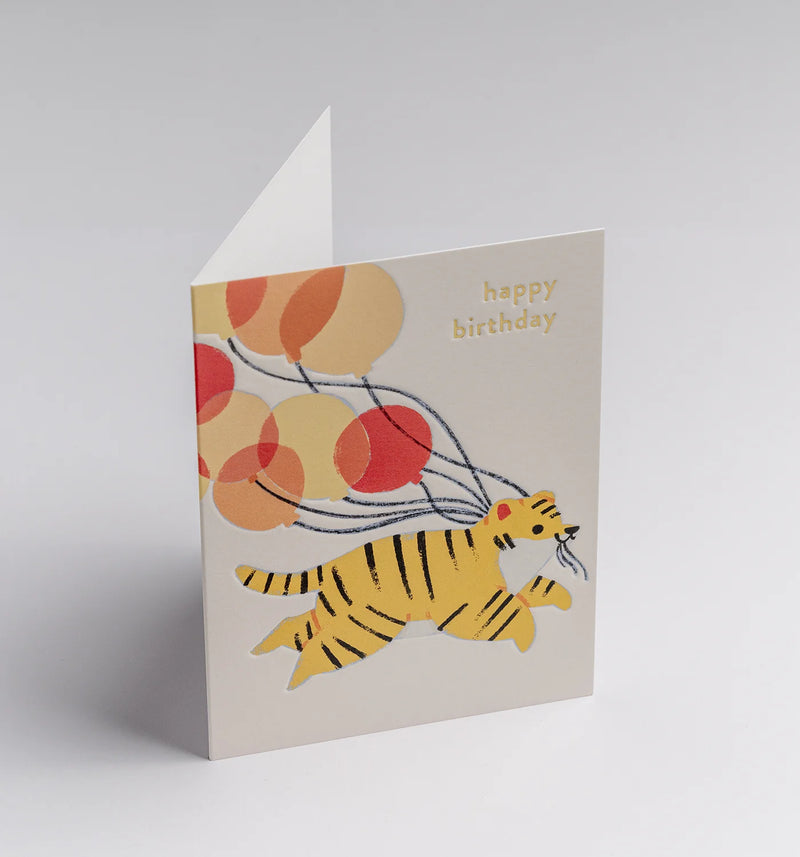 Greeting card with a tiger and balloons design on a light gray background