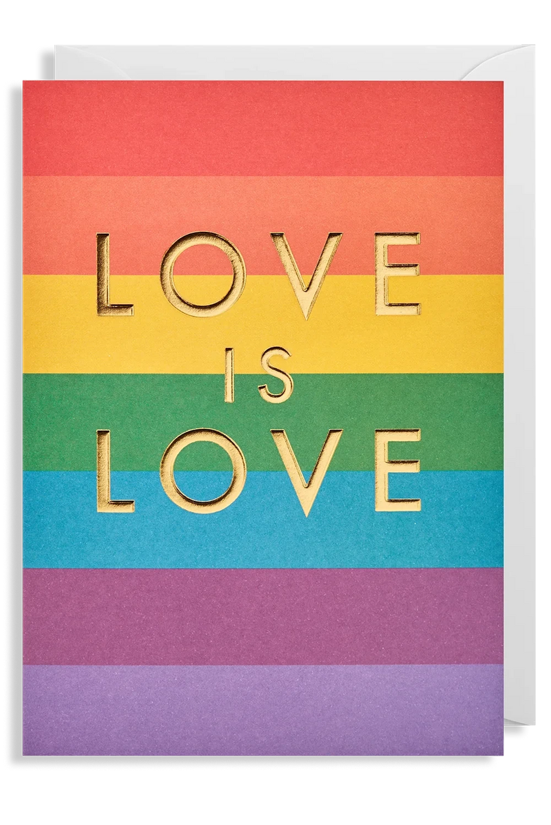 A rainbow striped greeting card with 'LOVE IS LOVE' written in gold letters, accompanied by a white envelope.
