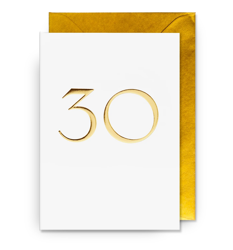 A white greeting card with '30' embossed in gold, accompanied by a gold envelope.