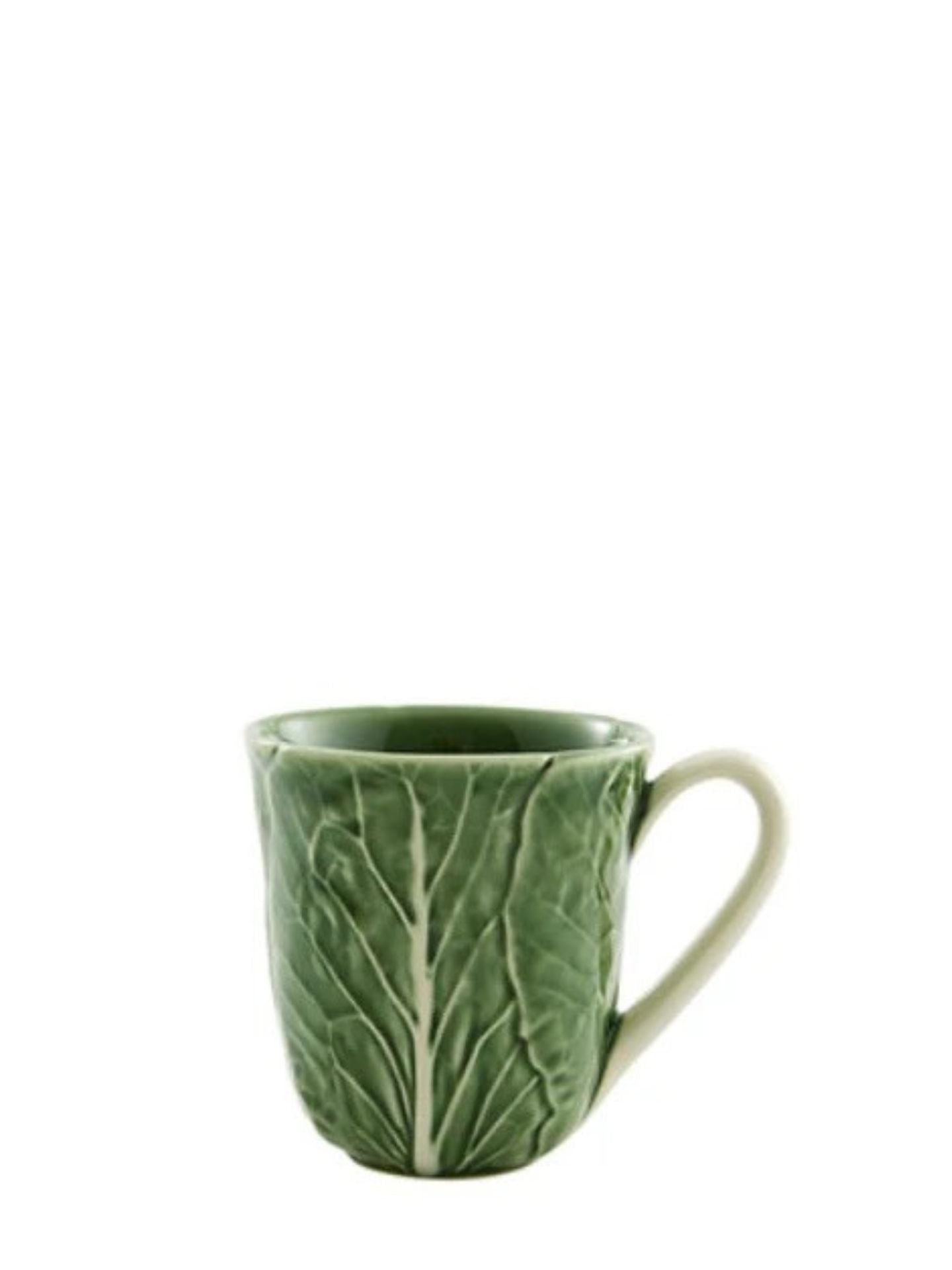 Green ceramic mug with leaf pattern on a white background