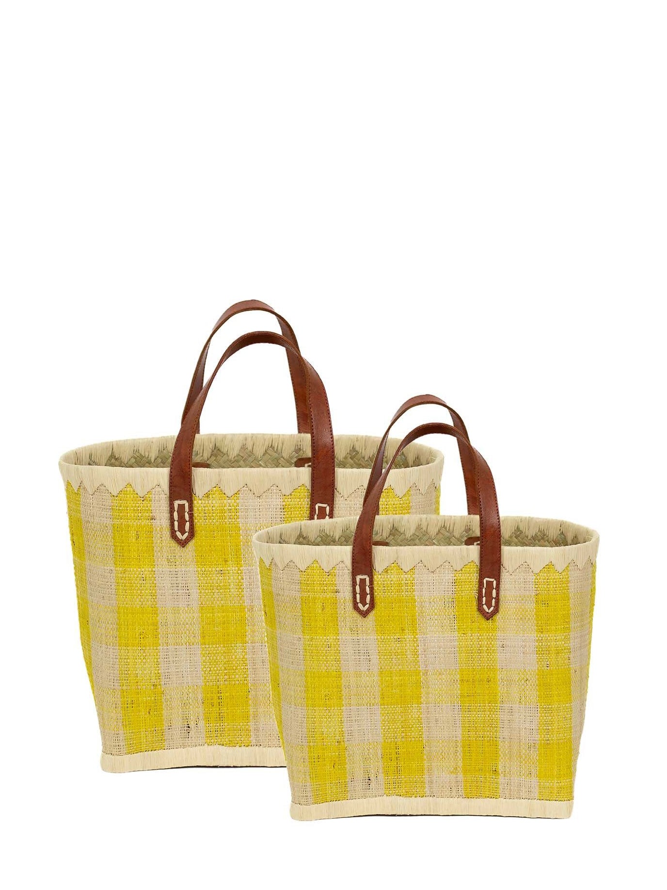 Two yellow and beige raffia tote bags with leather handles, one larger and one smaller, against a white background.