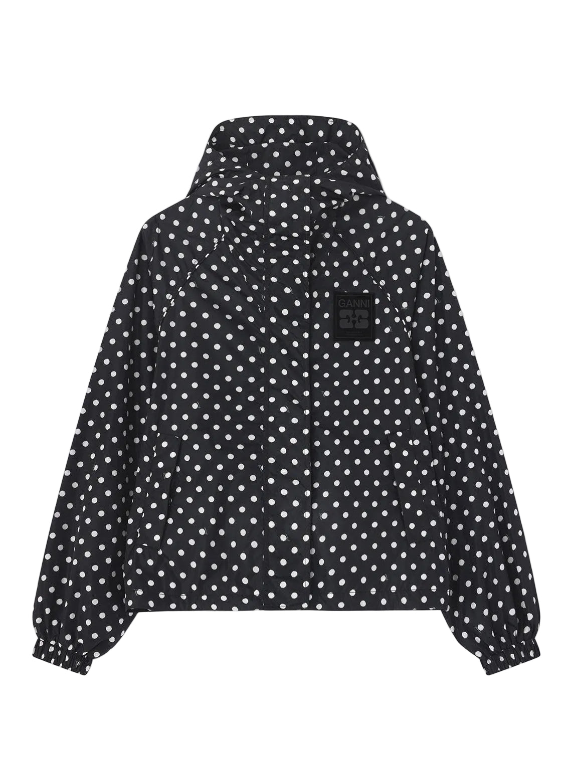 Black jacket with white polka dots on a light gray background