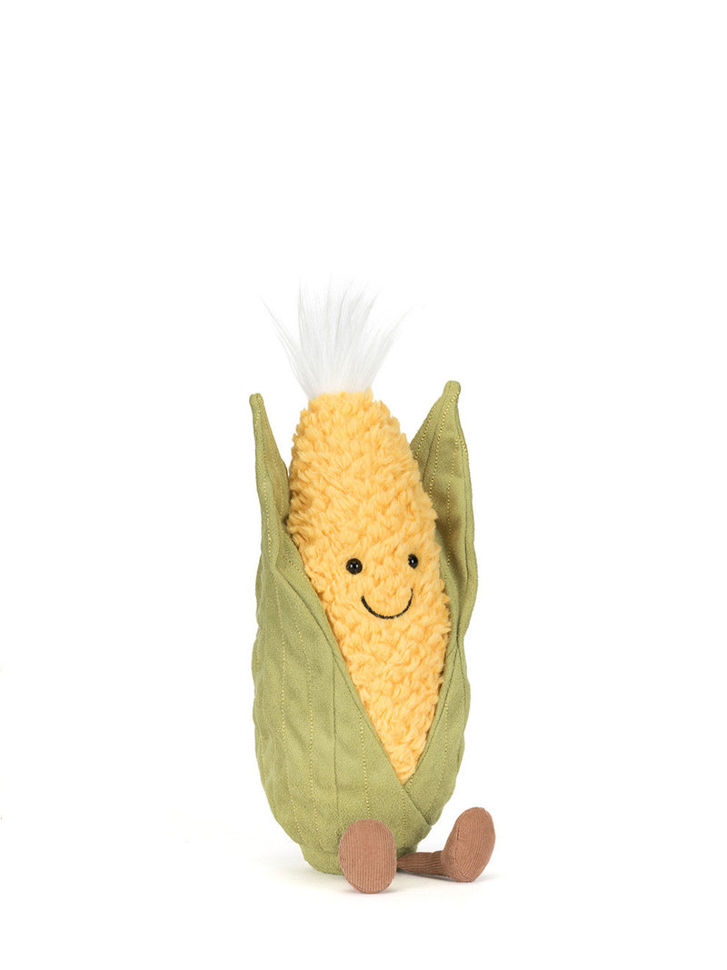 Plush toy resembling a corn cob with a smiling face on a white background