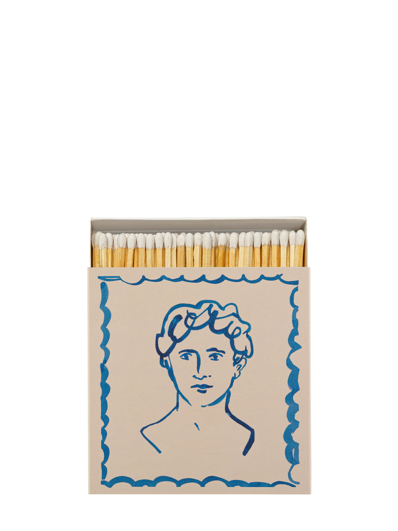 A matchbox with a illustration of a classical marble bust in blue on a beige background.