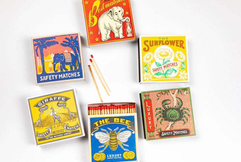 Collection of colorful matchboxes with animal illustrations on a white background