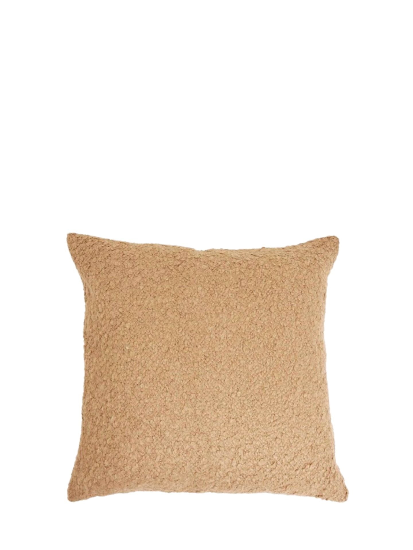 Beige textured pillow on a white background