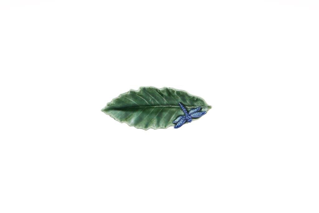 Decorative leaf-shaped object with a blue butterfly on a white background