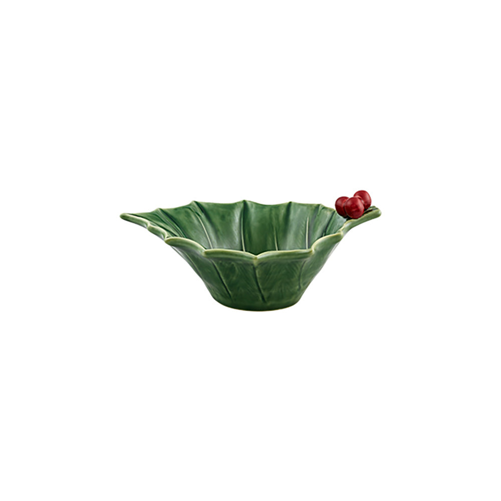 Green ceramic bowl with a scalloped edge on a white background