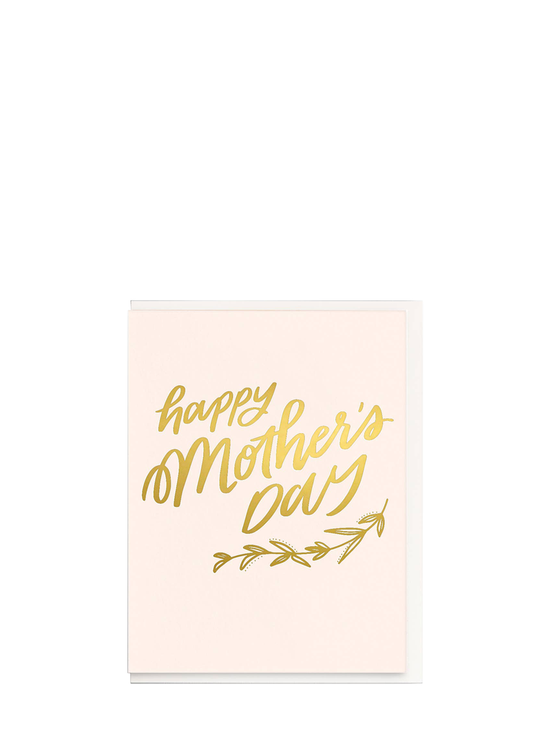 A greeting card with 'Happy Mother's Day' written in golden lettering on a pastel pink background, with a matching envelope.