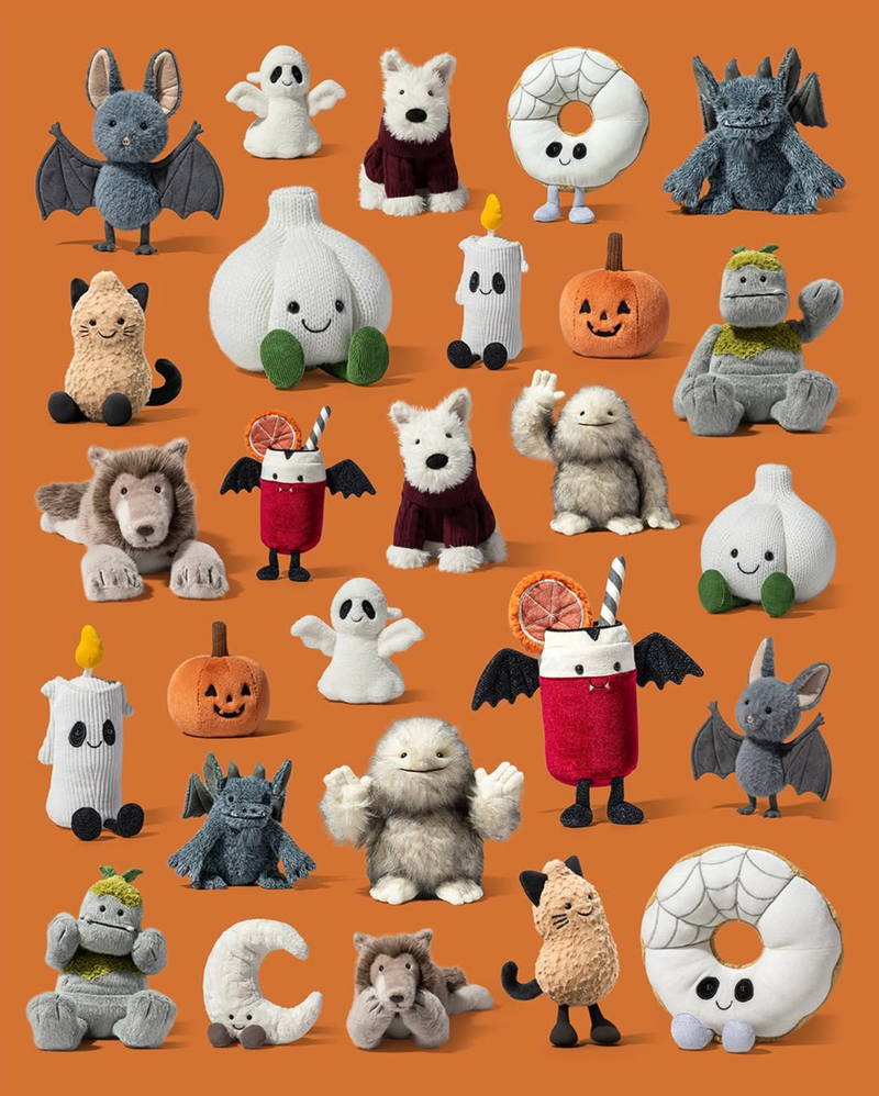 A collection of small plush toy characters arranged on a solid orange background, including ghosts, pumpkins, dragons, wolves, cats, mushrooms, and drink characters in Halloween-themed outfits.