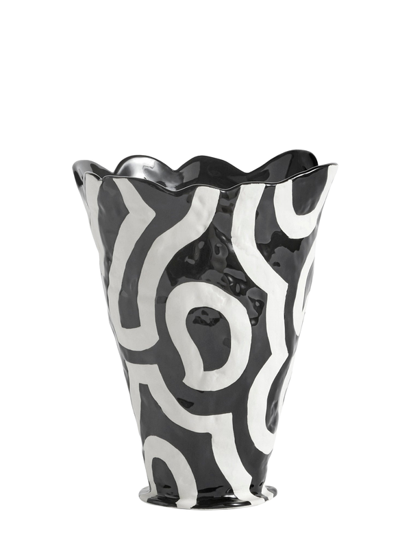 A black and white hand-painted stoneware vase with an abstract design.
