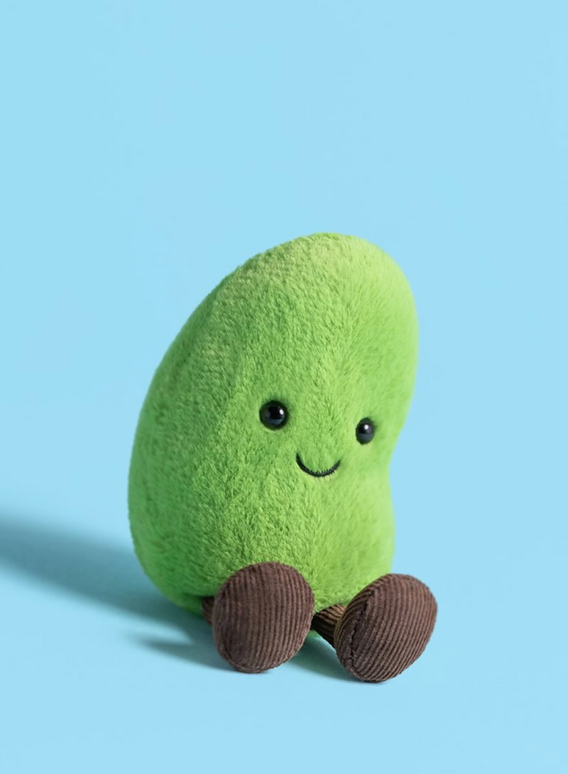 Plush toy edamame with a smiling face on a light blue background