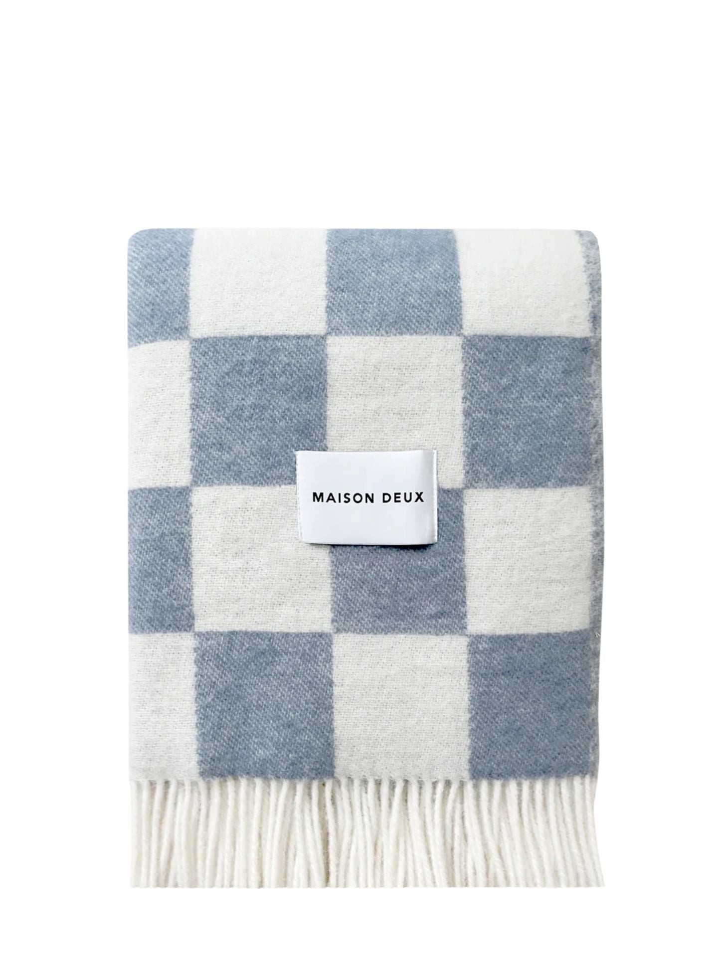 Checkered blanket with blue and white pattern and 'Maison Deux' label on a white background