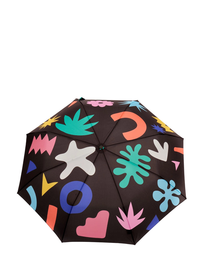 A colorful umbrella with a palm leaf pattern on a black background, featuring various playful designs such as hearts and stars.