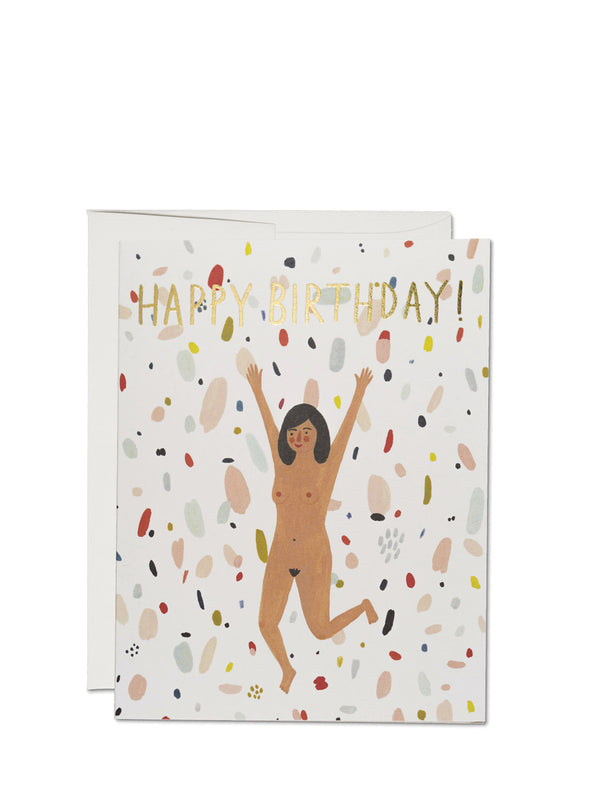 Illustrated birthday card with a figure jumping joyfully with text 'HAPPY BIRTHDAY!' above, on a speckled background. Includes an envelope.