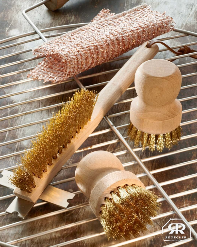 Set of metal brushes with wooden handles on a metal surface, featuring the Redecker brand.