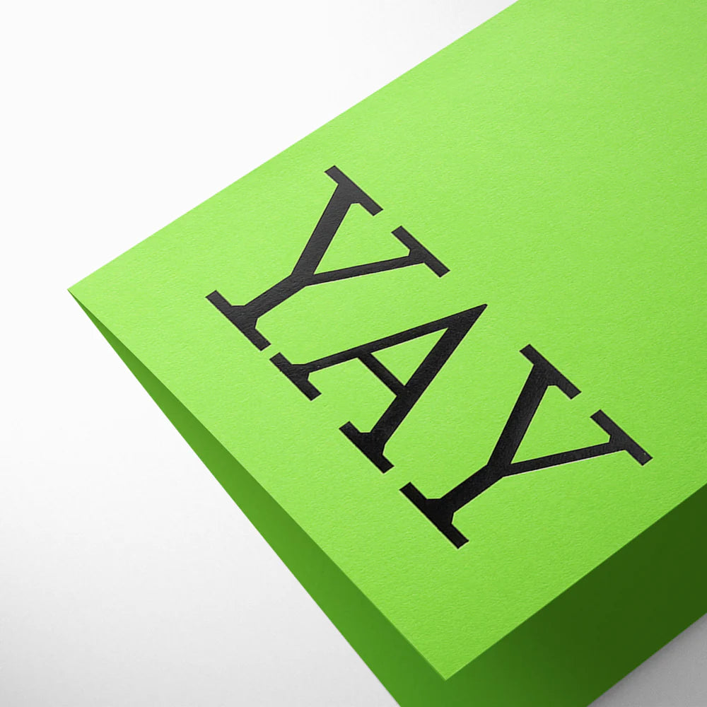 Green card with 'YAY' printed on it against a white background