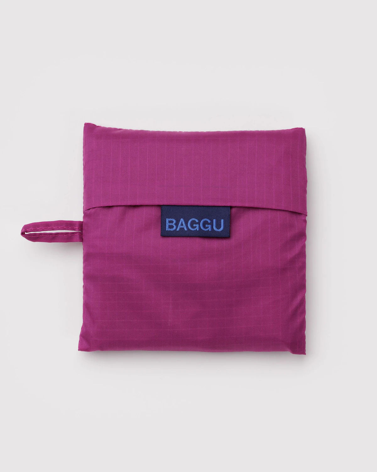 Purple reusable bag with 'BAGGU' logo on a light gray background