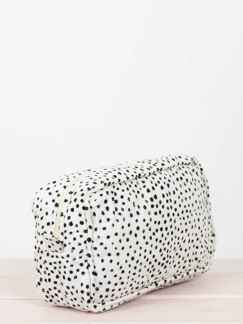 Rectangular pouch with black polka dots on a white background