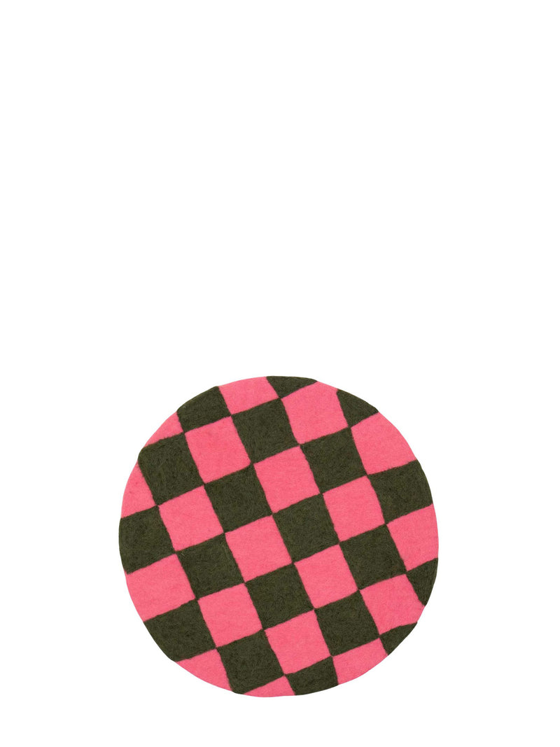 Checkered pink and dark green round seating pad made from felted wool pictured on a white background