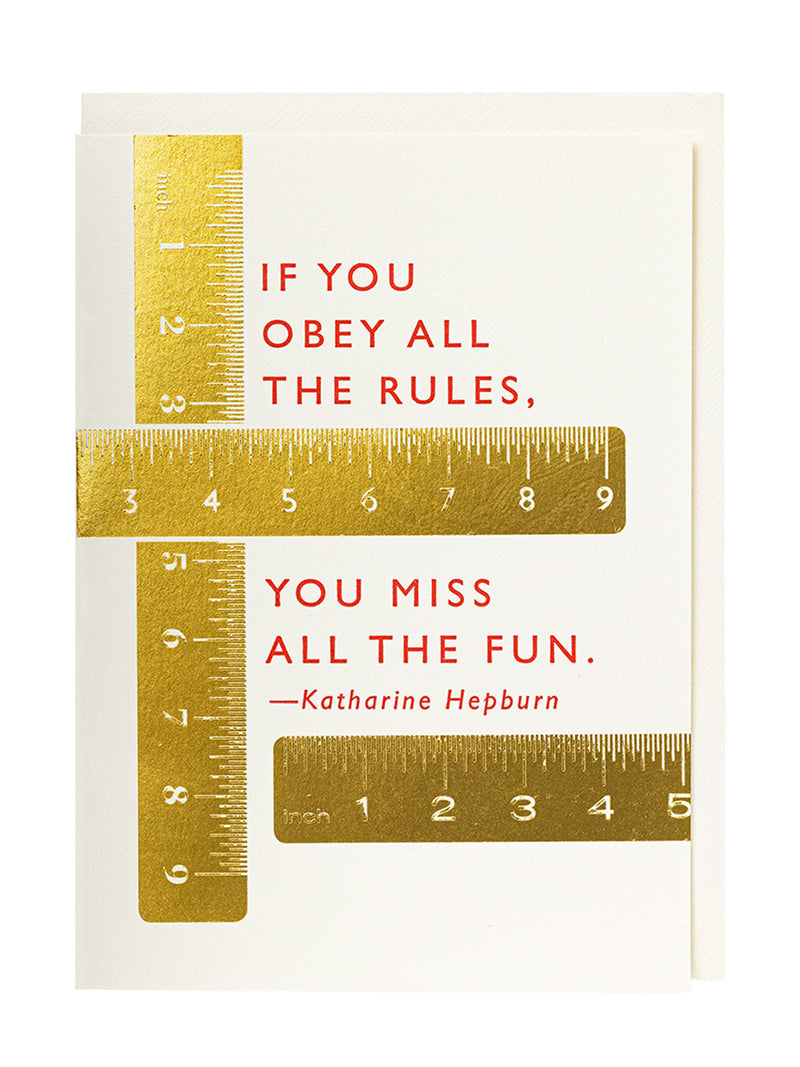 A square greeting card with a white background and gold foil ruler graphics, featuring the quote 'IF YOU OBEY ALL THE RULES, YOU MISS ALL THE FUN.' attributed to Katharine Hepburn in red text, with a fitting white envelope behind the greeting card