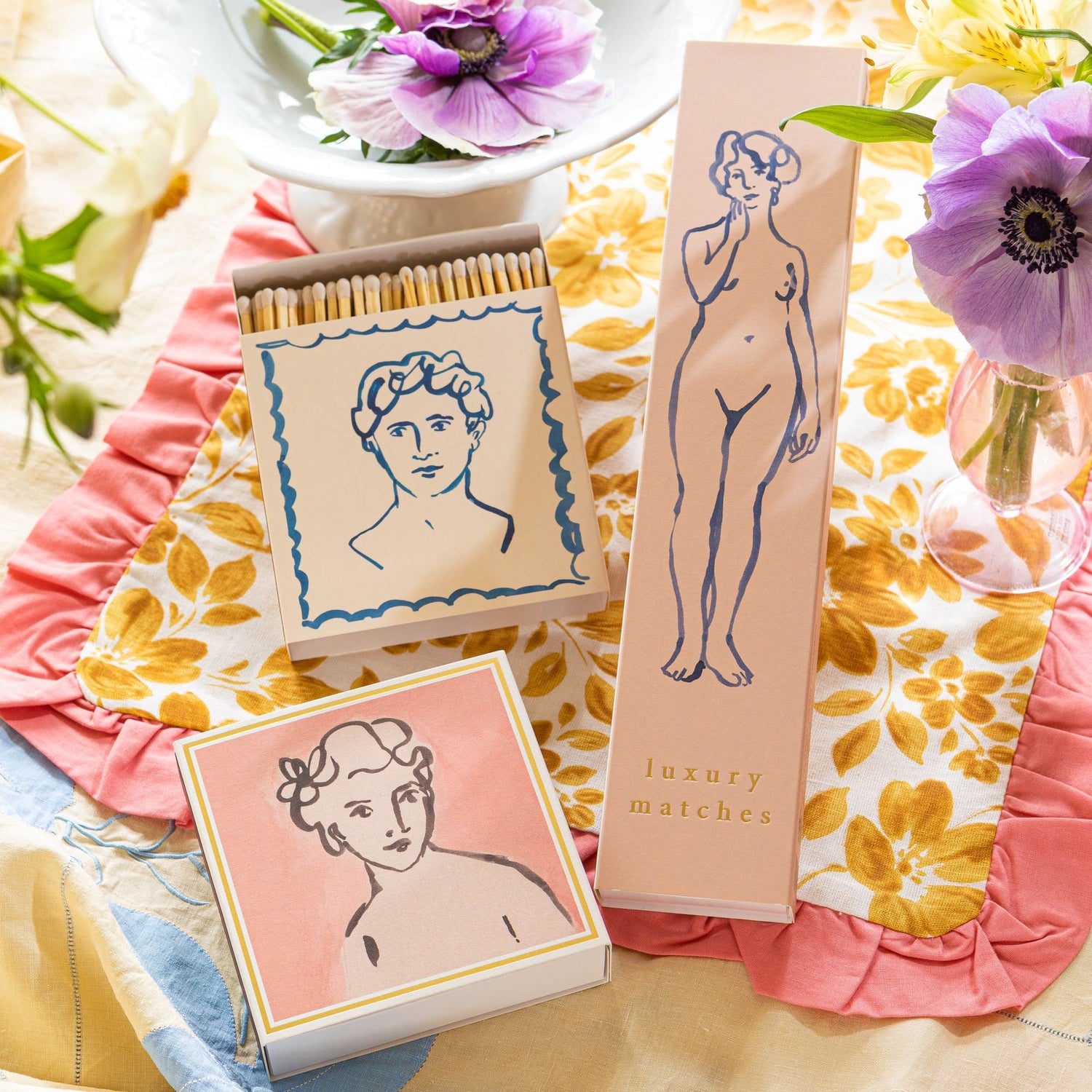 Matches with artistic designs on a floral surface