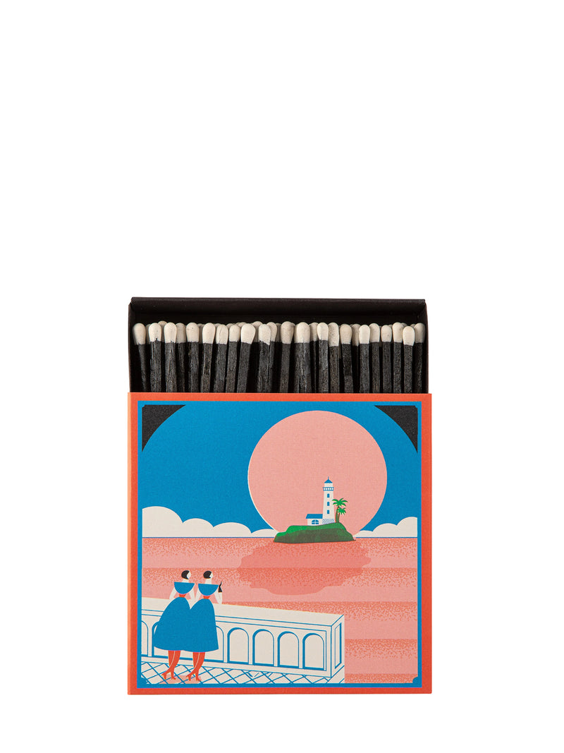 Matches in a decorative box with a lighthouse design on a white background