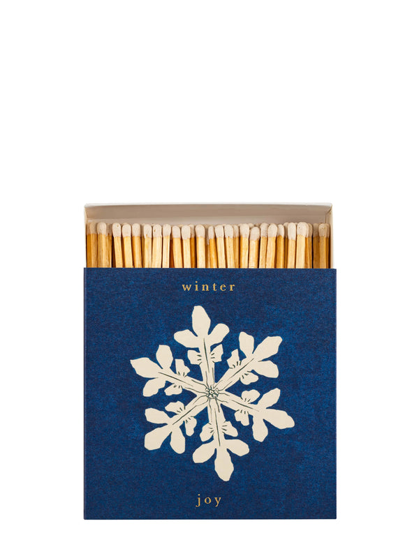 Matches with a blue box featuring a snowflake design and the text 'winter joy' on a white background.