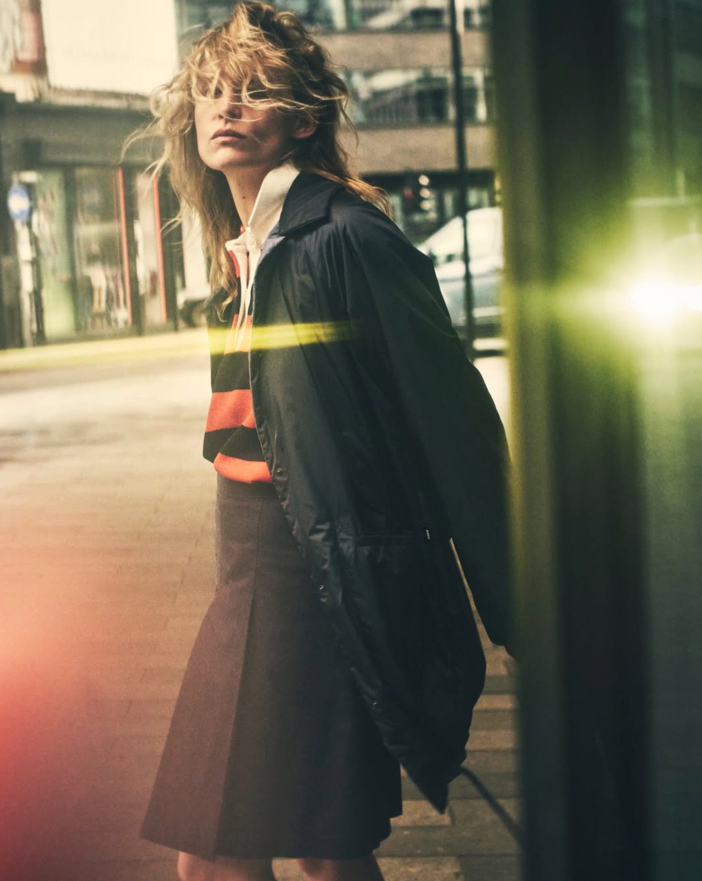 Person walking on a city street with a blurred background