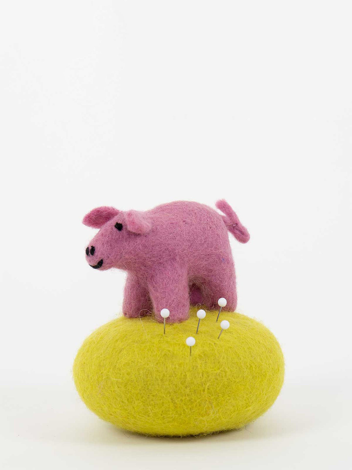 Pig on a stone pincushion