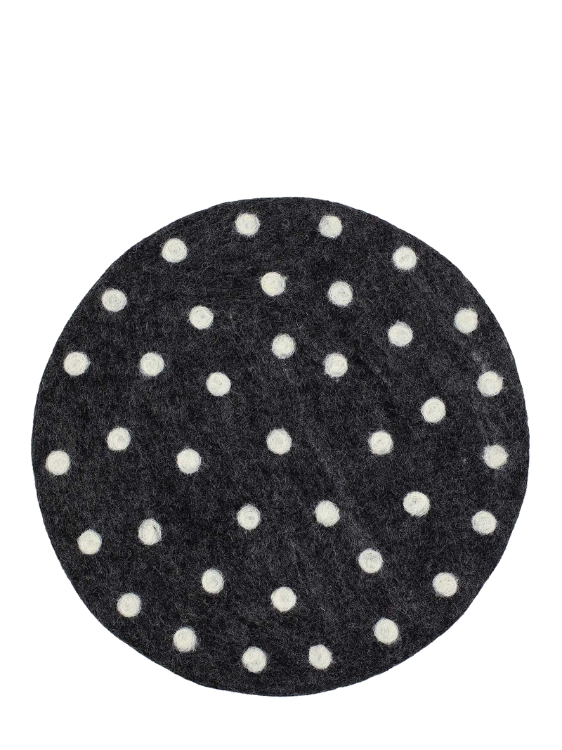 Round charcoal grey felted seating pad with white polka dots pictured on a white background
