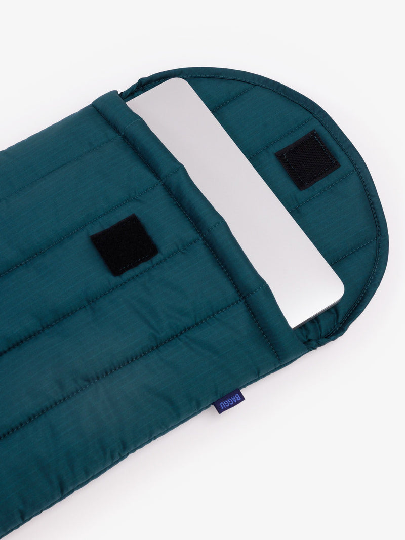 Teal tech carrier with a white handle on a white background