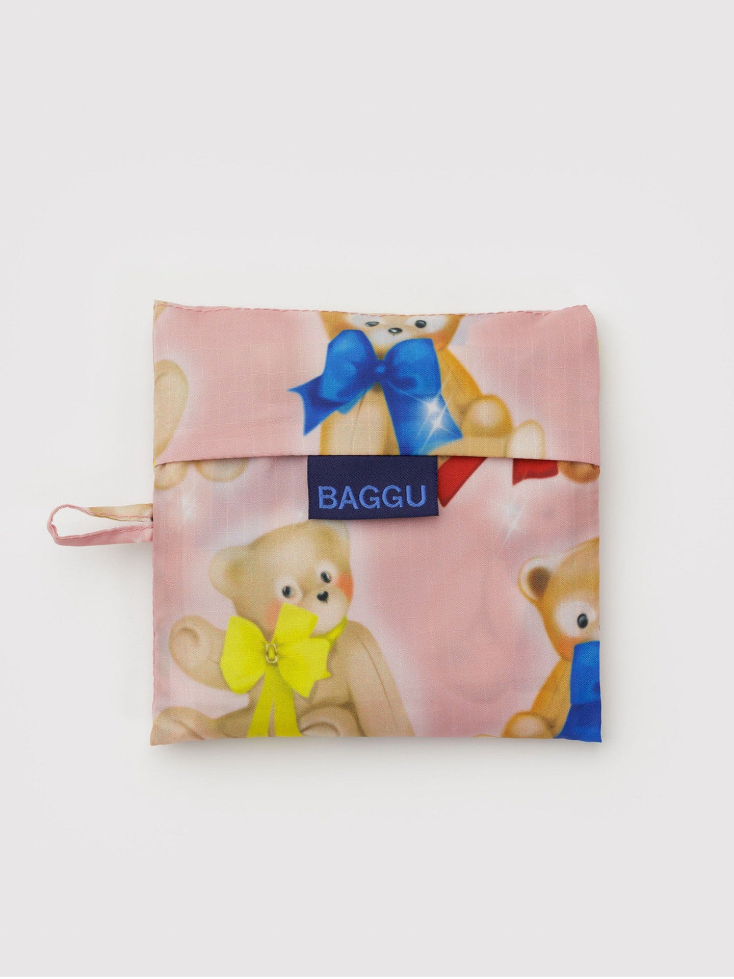 Pink reusable bag with teddy bear design and 'Baggu' branding on a white background