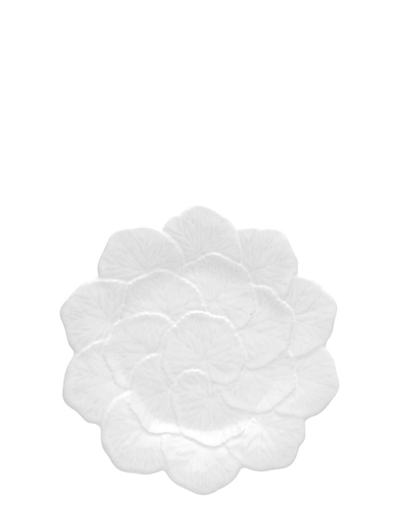 A white ceramic serving dish designed to resemble a flower, with a smooth texture and a rounded shape.