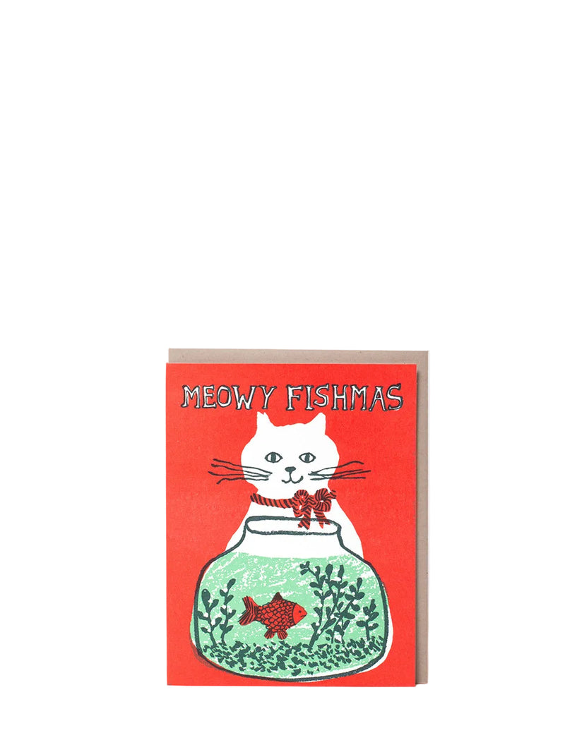 A greeting card featuring a white cat sitting in a green fishbowl with a red fish, set against a bright red background with the text 'MEOWY FISHMAS'.