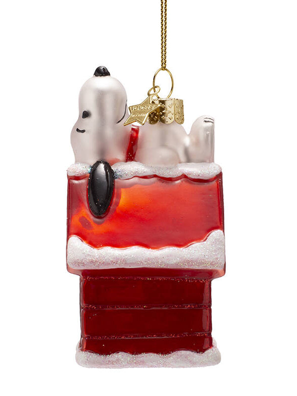 Decorative ornament with Snoopy laying on the roof of a doghouse