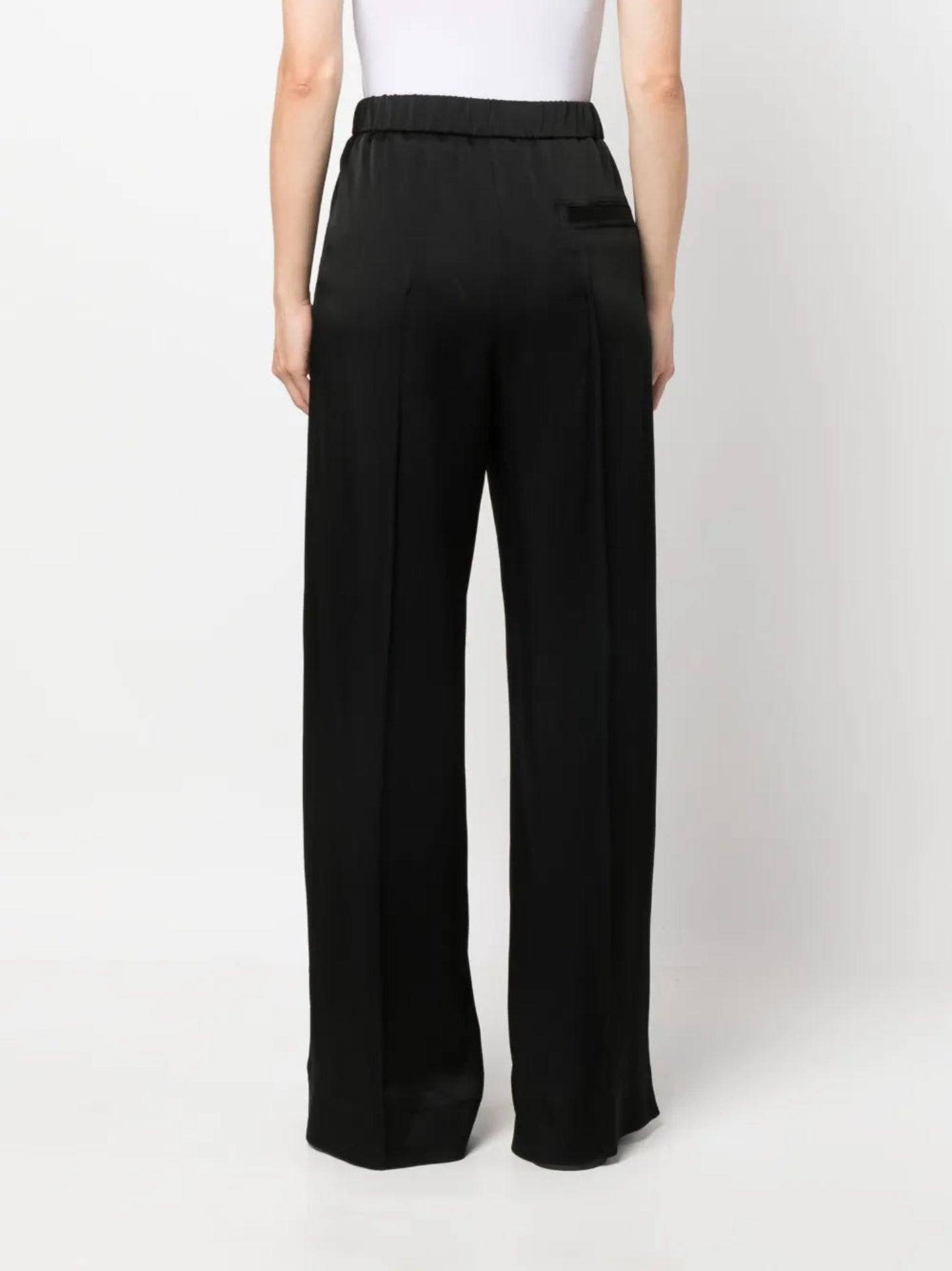 Black wide-leg pants worn by a person on a white background