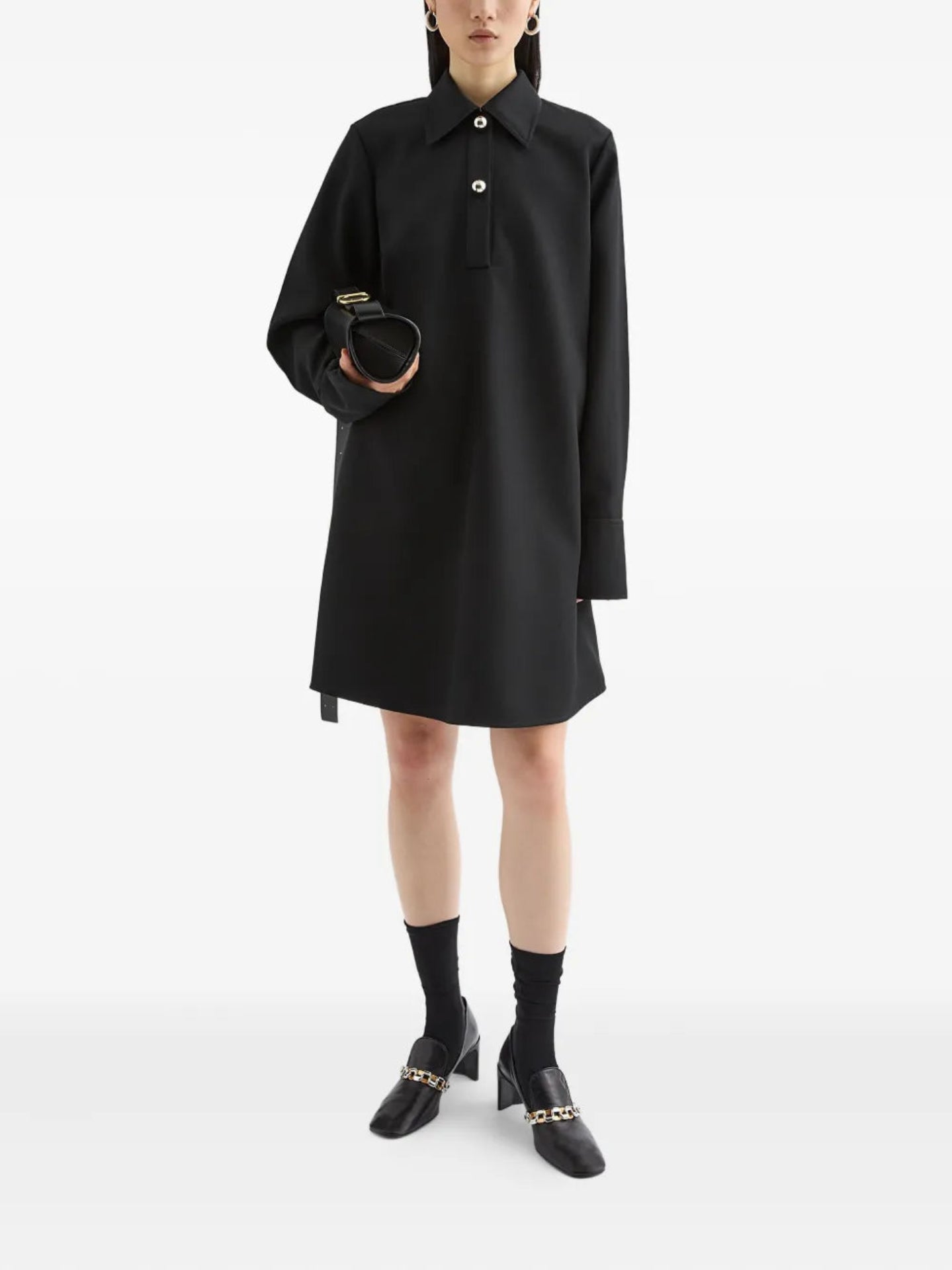 Person wearing a black dress with a white background