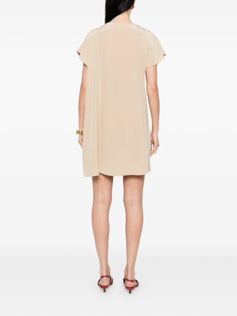 Beige dress worn by a model on a white background