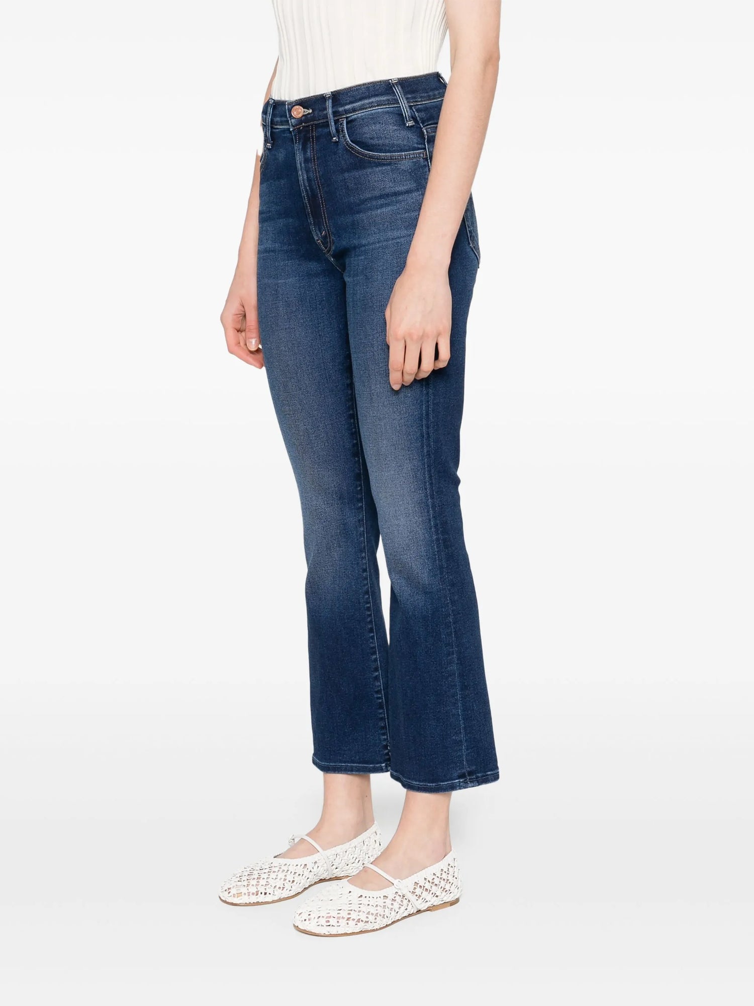 Person wearing blue jeans on a white background