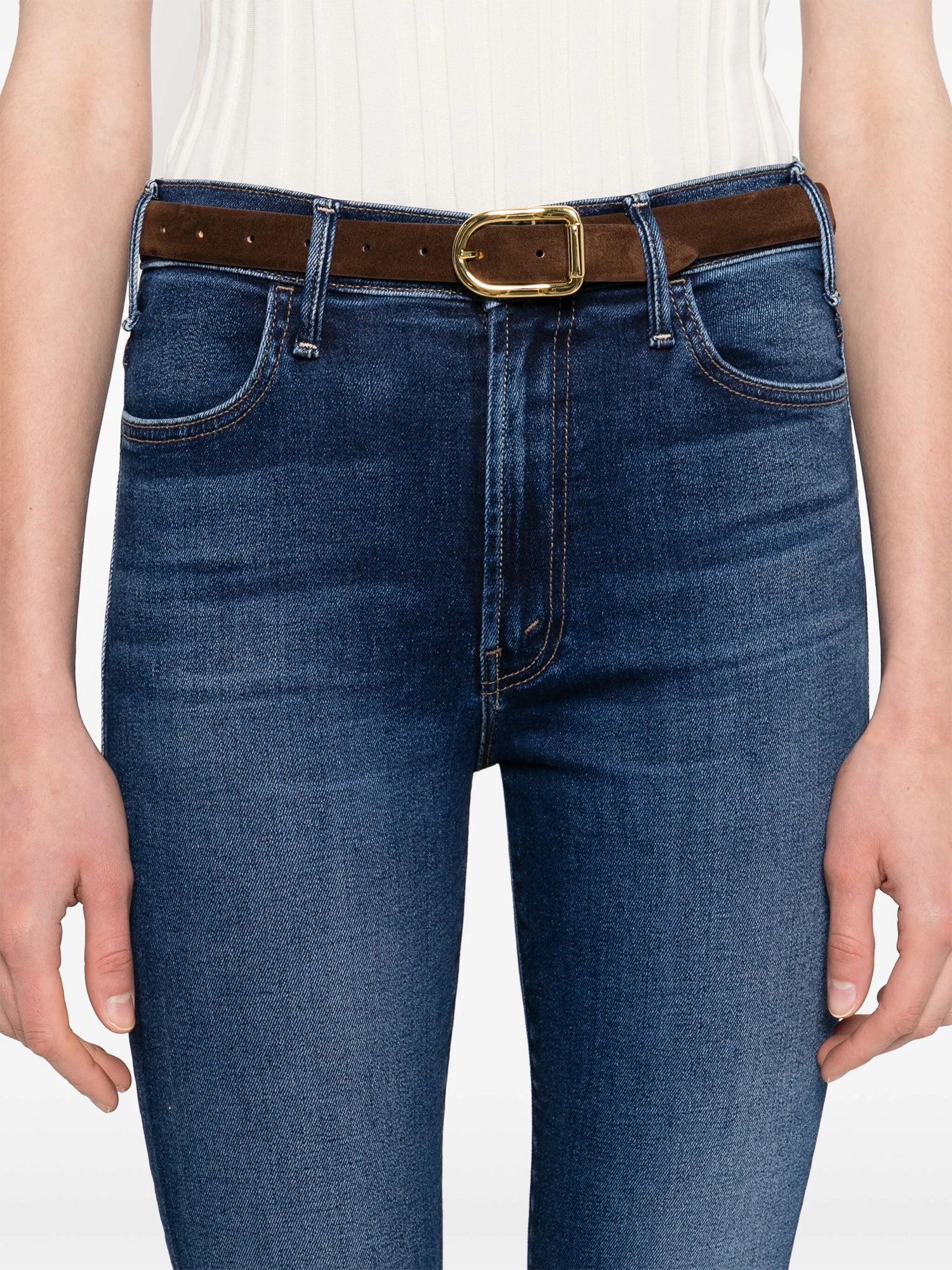 Blue jeans with a brown belt and gold buckle on a white background