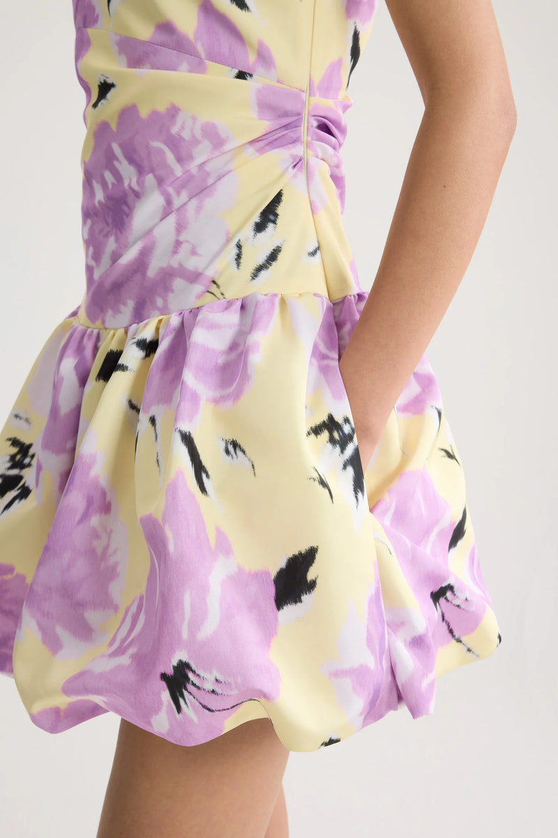 Yellow dress with purple floral pattern on a white background