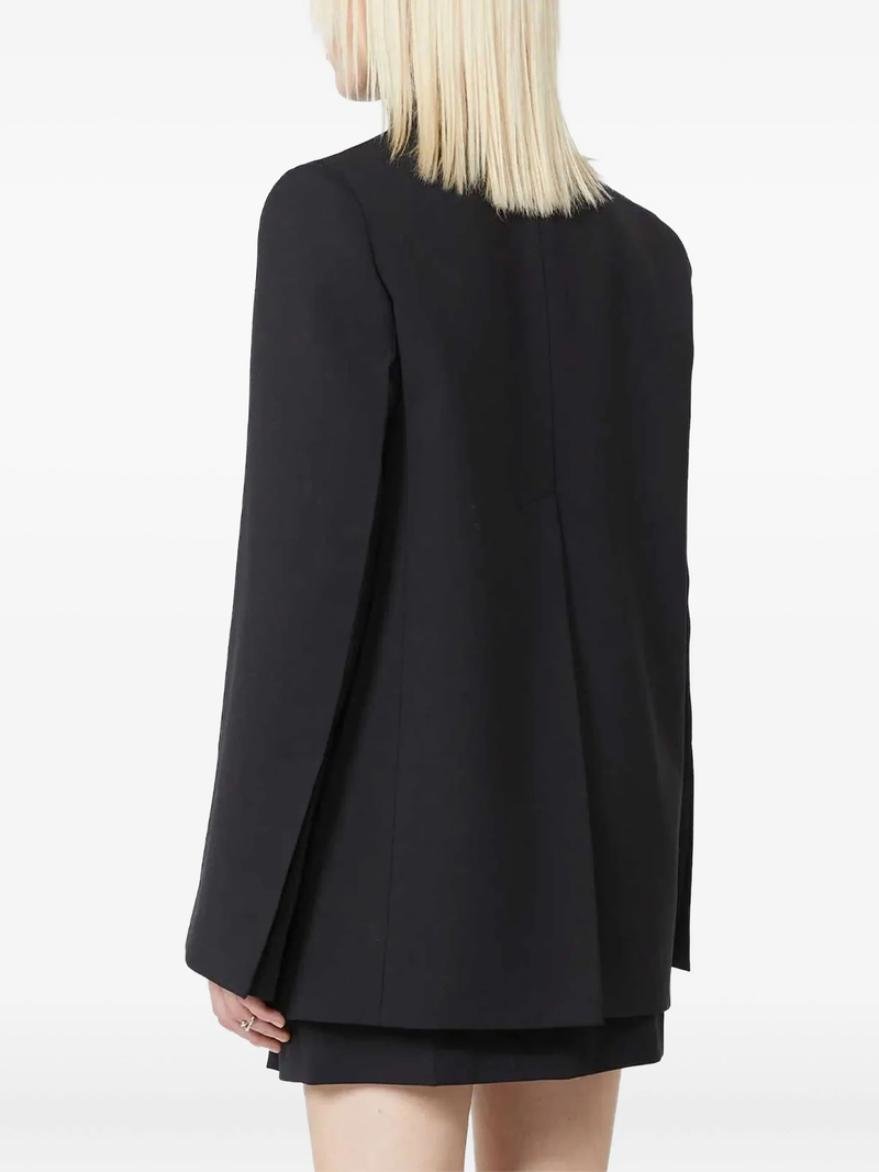 Black blazer worn by a person on a white background