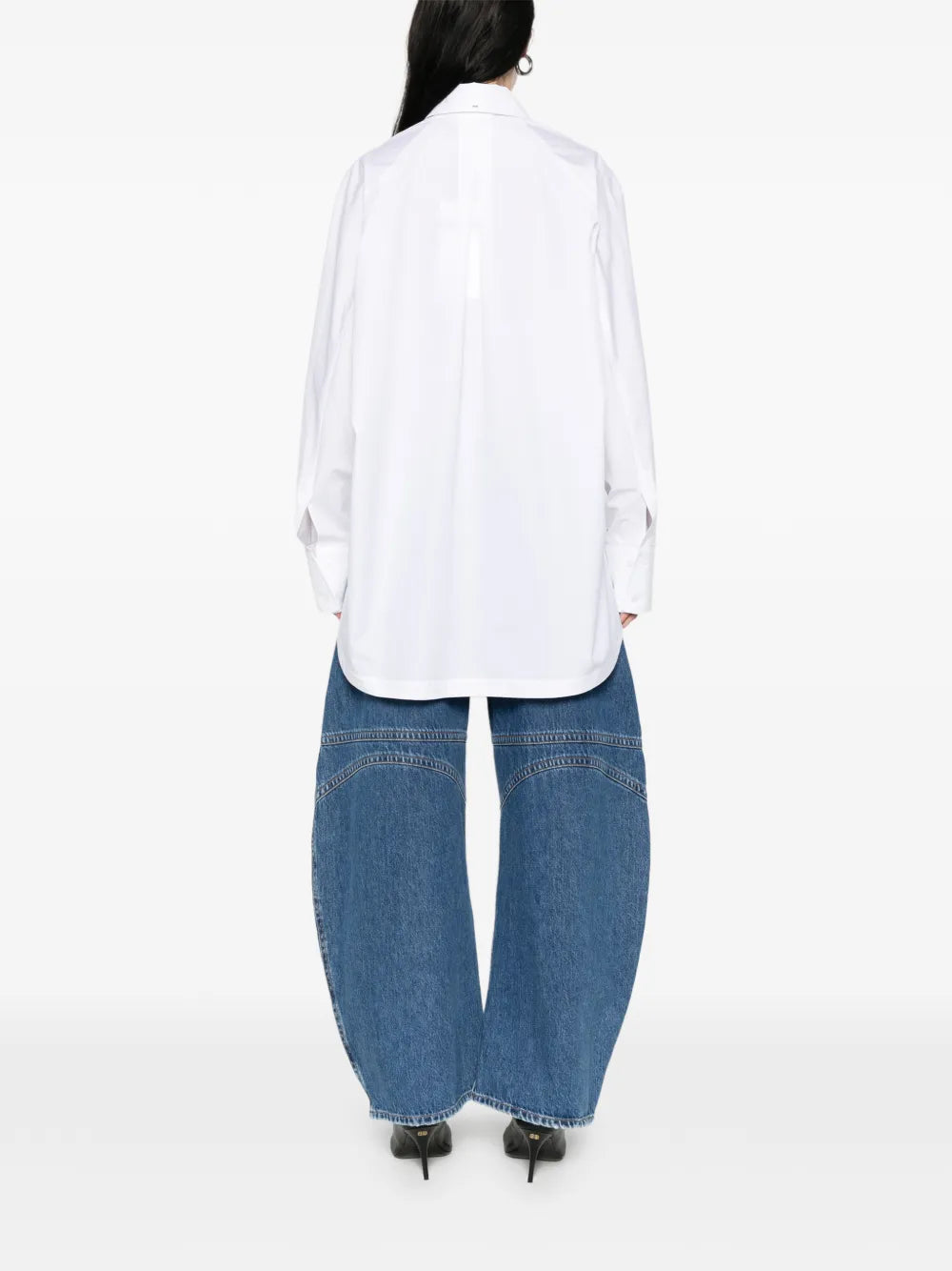 Person wearing a white shirt and blue jeans on a white background