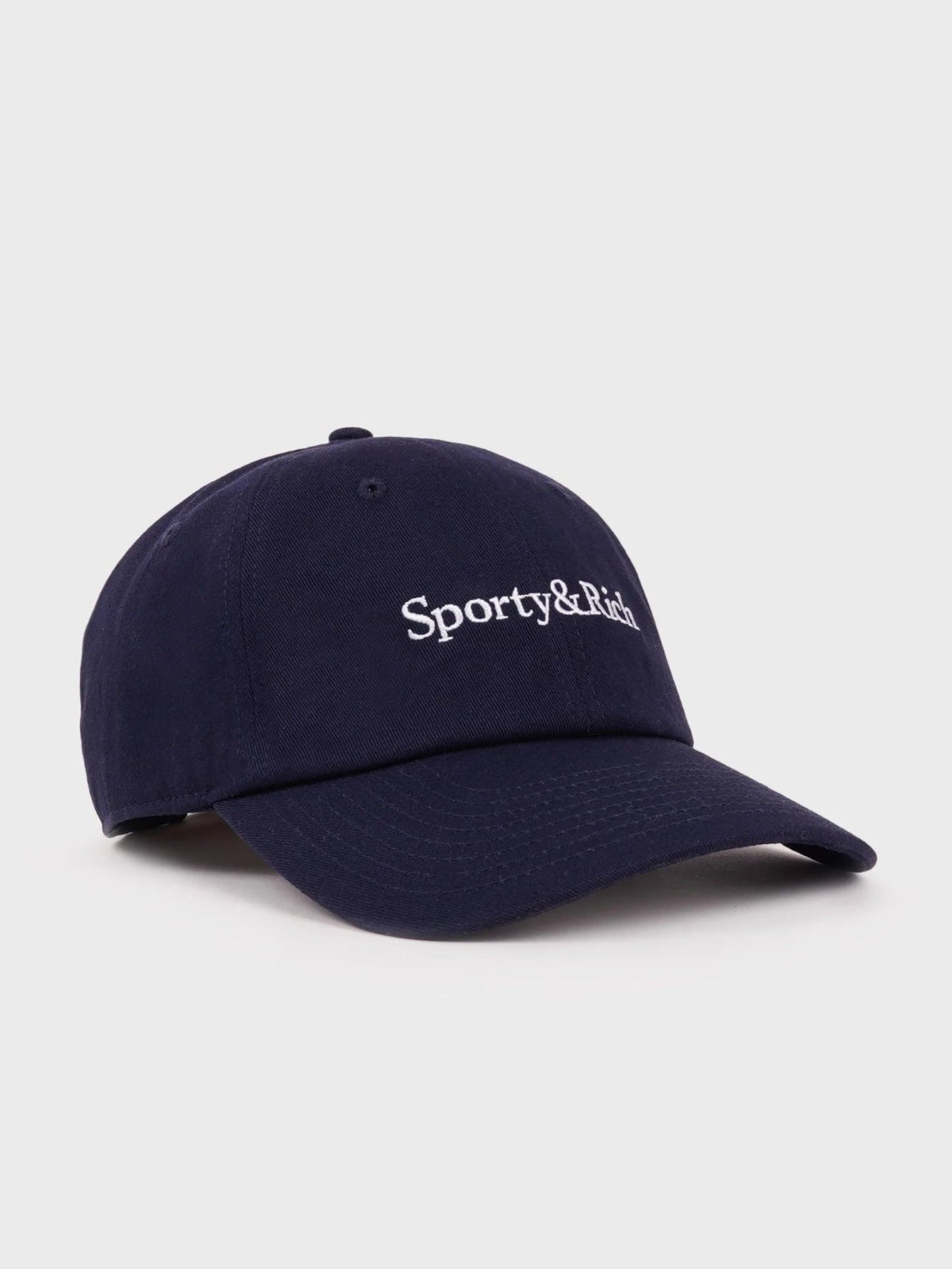 Navy blue cap with 'Sporty & Rich' logo on a light gray background