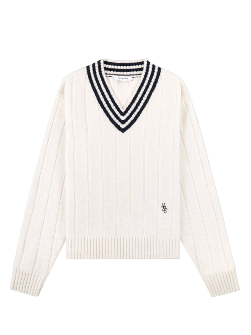Cream cashmere sweater with navy stripes and cable knit against white background